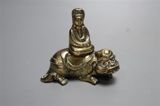 A small 18th century Chinese bronze group of Guanyin seated on a recumbent mythical beast, height 6cm